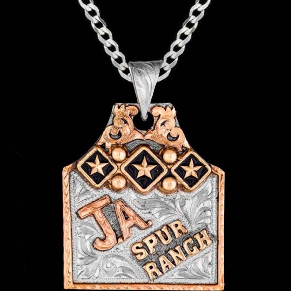 The Butterscotch Cow Tag Necklace features a captivating bead and stars edge frame on a fine hand engraved german silver base. Customize it with your bronze lettering and back engraving now!